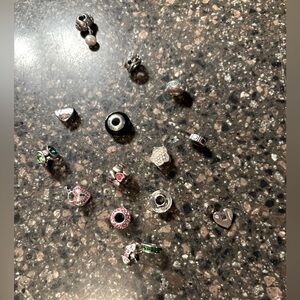 All 15 Pandora charms. One says Grandma, most have stones or a pearl/Blingy.